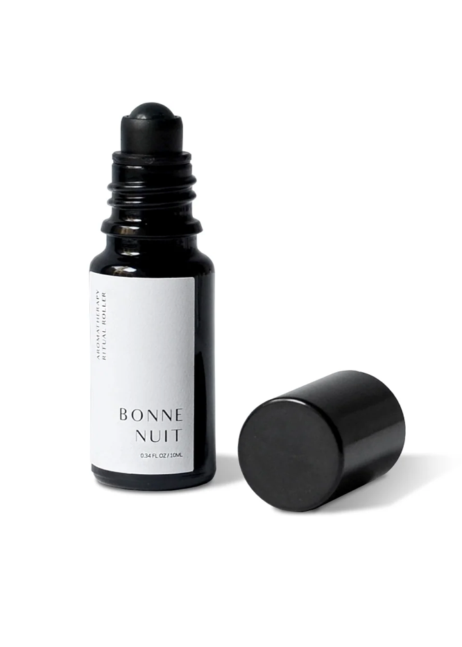 Black bottle of 'Bonne Nuit' with a white label on a white background