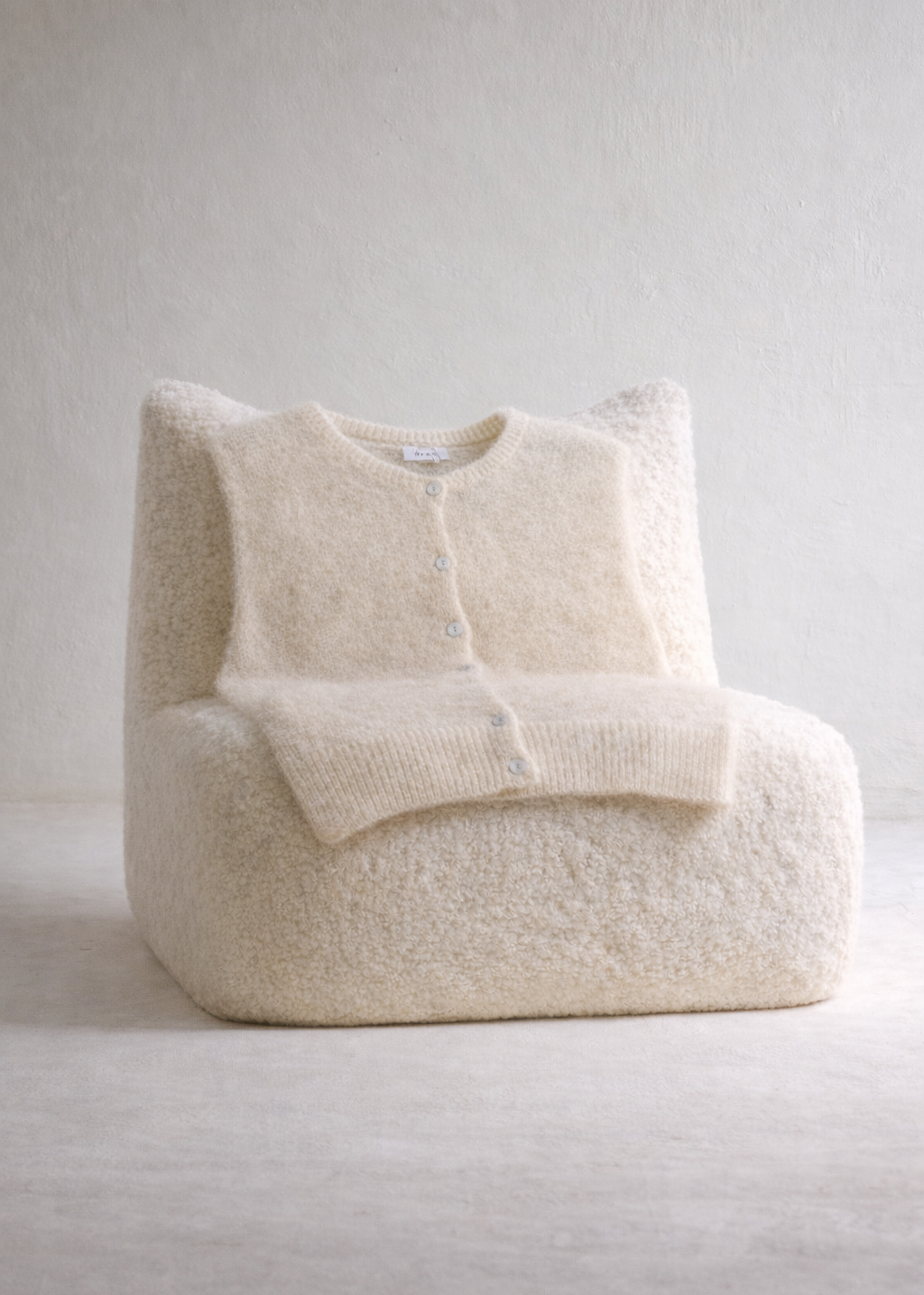 Cream-colored bean bag chair on a light gray background