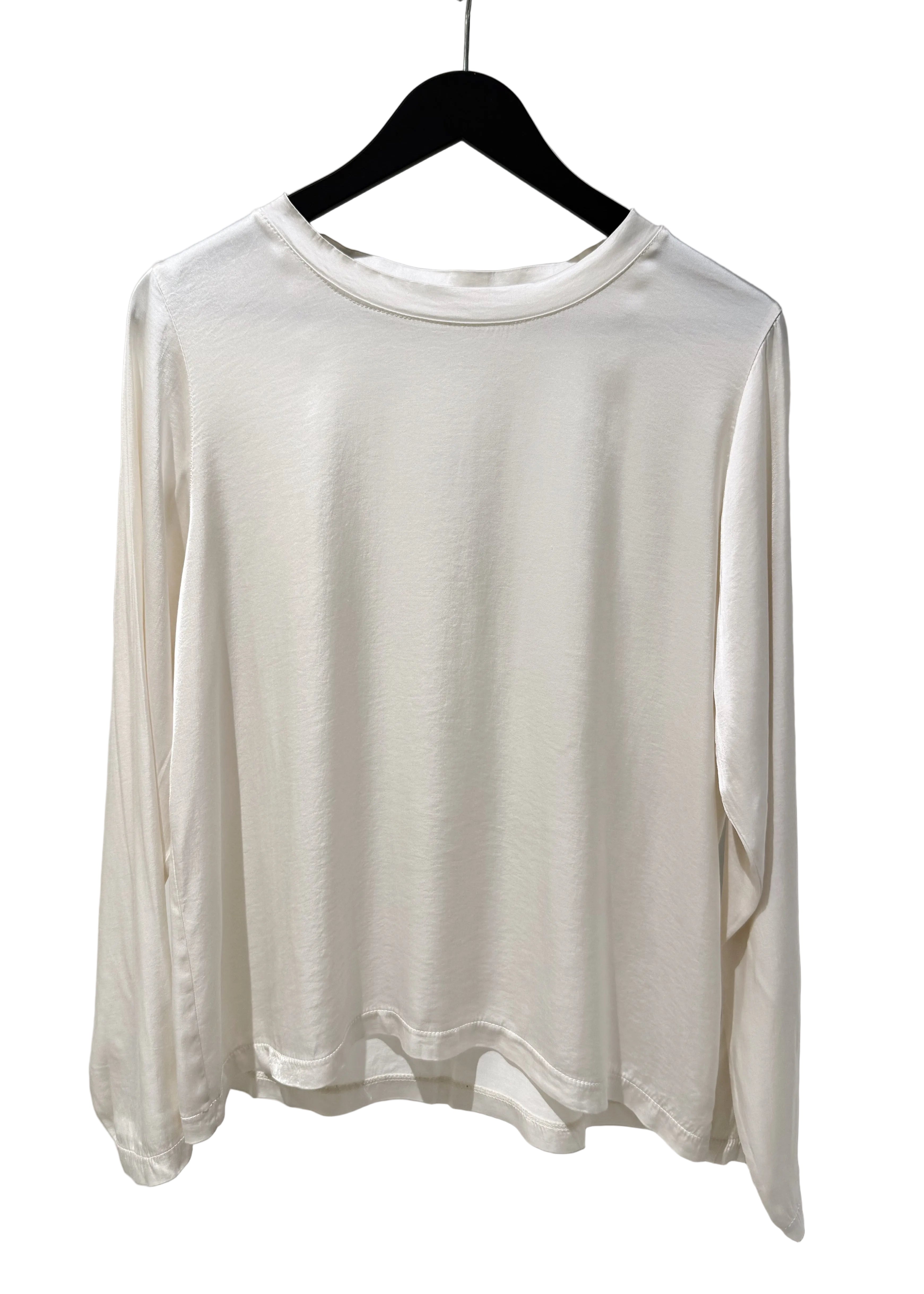 White long-sleeve shirt on a hanger against a plain background